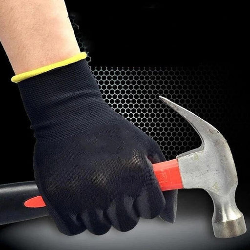 The image highlights the grip and protection offered by the black work glove while holding a hammer. The glove has a yellow hem at the wrist.