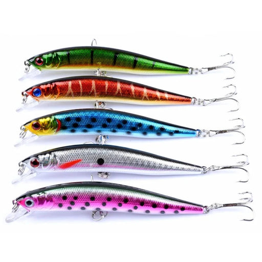 A set of five colorful fishing lures arranged in a row, each with a different vibrant pattern including green, red, blue, silver, and pink, all equipped with treble hooks.