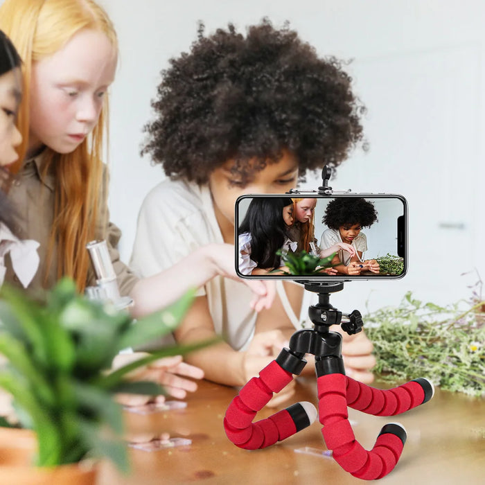 Children using a flexible tripod to record a video for a creative project.