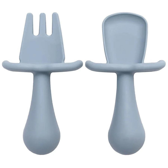 A close-up shot of two blue silicone baby utensils, a fork and a spoon, showing their detailed design and texture.