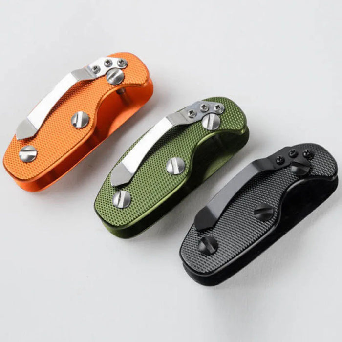 A closer view of the three key organizers from a different angle, showcasing their metal clips and textured designs in orange, green, and black.