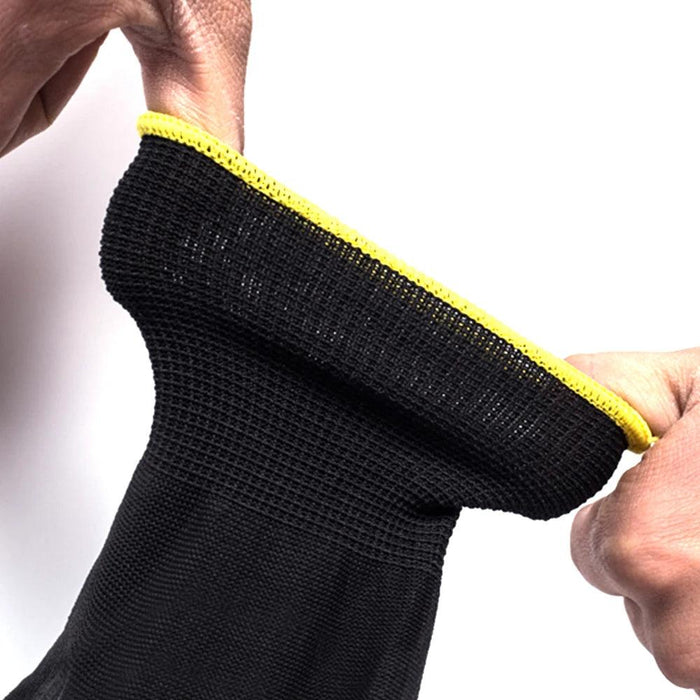 This close-up image highlights the stretchability and flexibility of the glove. The glove features a yellow hem at the wrist.