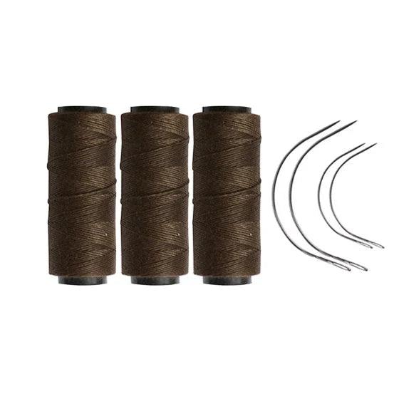 Three dark brown rolls of sewing thread with four needles.