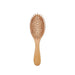 A bamboo hairbrush with a rounded rectangular shape and wooden bristles.