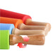 a close-up view of four rolling pins in different colors—red, orange, blue, and green—each with wooden handles. The handles have a smooth finish, and there is a red arrow pointing to indicate a rolling motion.