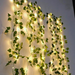 A wall fully decorated with green ivy and lights, creating a stunning visual effect. The lights cast a soft glow that highlights the natural green, making the space vibrant and enchanting, ideal for enhancing ambience in any room or outdoor setting.