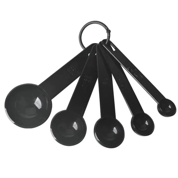 a set of five black measuring spoons, also fanned out and connected by a ring. The spoons come in various sizes, with measurement markings on the handles. They have a shiny finish, indicating a similar material to the measuring cups.