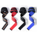 Four different pairs of lifting straps laid out in a row. The colors include black with orange stripes, red, black with gray stripes, and blue with gray stripes. The wrist support pads are visible at the top of each strap.