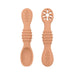 A close-up of two peach baby spoons, one with a regular spoon shape and the other with a cut-out flower design, against a white background.