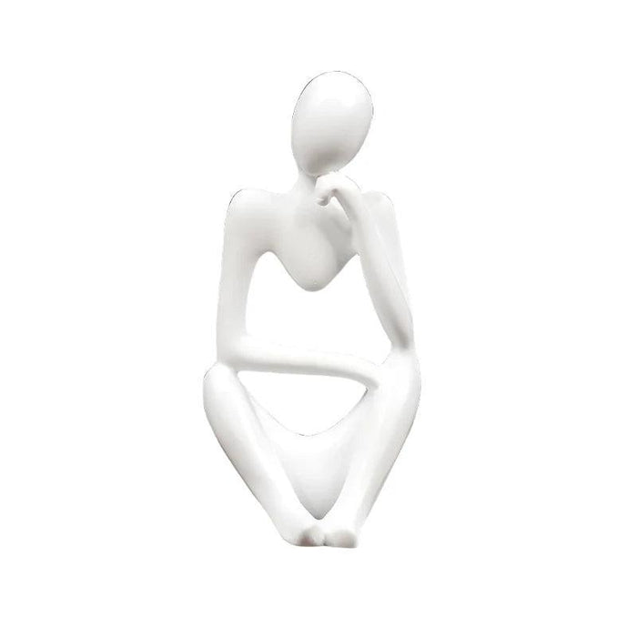 White minimalist abstract sculpture of a figure sitting with one hand resting on the chin.