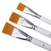 Three white-handled flat paintbrushes with orange bristles alongside a packaging of three similar brushes.