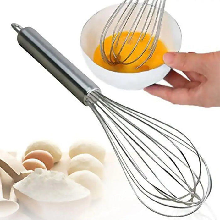 A stainless steel whisk in action, beating an egg mixture in a bowl. Eggs and flour are seen in the background, creating a baking preparation scene.