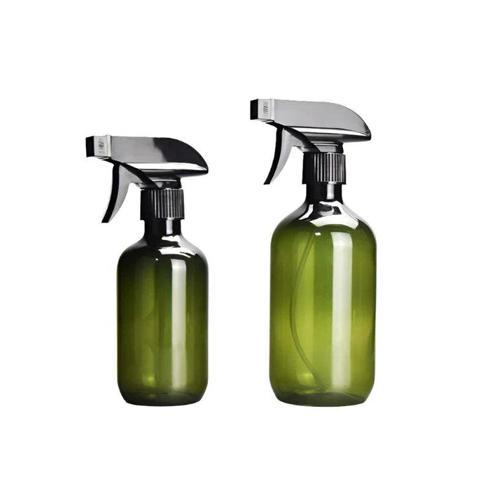 Two green spray bottles of different sizes with black spray heads, standing side by side.