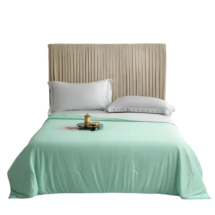 Green Cooling Blanket display on a bed.