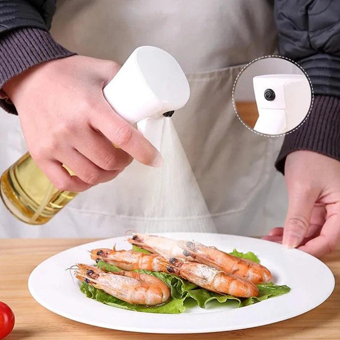 A white oil spray bottle being used to spray oil onto  a plate with shrimps. There is a close up on the part of the spray hole of the bottle.