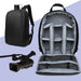 Open camera backpack with a gray interior, displaying compartments for camera gear and accessories.