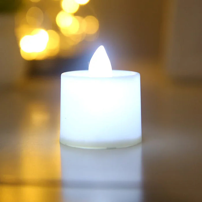 A close-up of a single white LED tea light candle emitting a bright white light, emphasizing the simple and clean design.