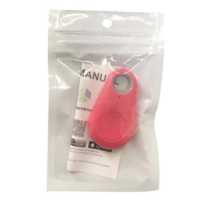 The GPS tracker in red, packaged in a transparent plastic bag. The packaging includes an instruction manual with a QR code visible through the bag. The tracker has a button and a small hole at the top.