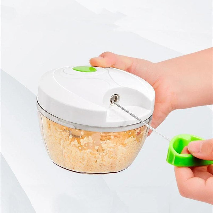 A person using the mini chopper with garlic inside.