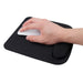 A hand using a white mouse on a black ergonomic mouse pad with wrist rest, displayed on a white background.