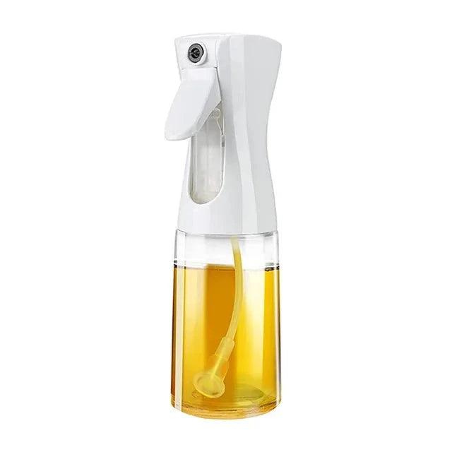 A close-up image of a white oil spray bottle filled with oil, against a white background.