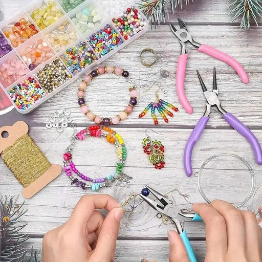 A crafting station featuring pink and purple-handled jewelry pliers, a bead organizer with various beads, completed beaded bracelets, and earrings, with hands actively using the pliers to craft jewelry.