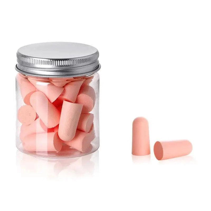 A small jar filled with pink earplugs. With 2 pink earplugs beside it.