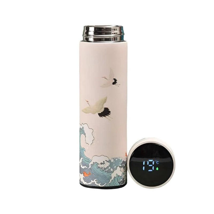 A tall, cylindrical thermos with a white body, adorned with illustrations of flying cranes and ocean waves. The lid, placed next to the thermos, displays a digital temperature reading of 19°C.