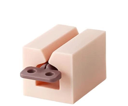 Pink toothpaste squeezer with a brown key.