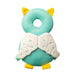 A green owl-shaped baby head protector with yellow feet and detailed wings decorated with small green V-shaped patterns.