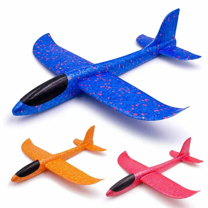 three assembled foam gliders in blue, orange, and red. Each glider has a black nose, and the vibrant colors with speckles give them a playful, eye-catching appearance.