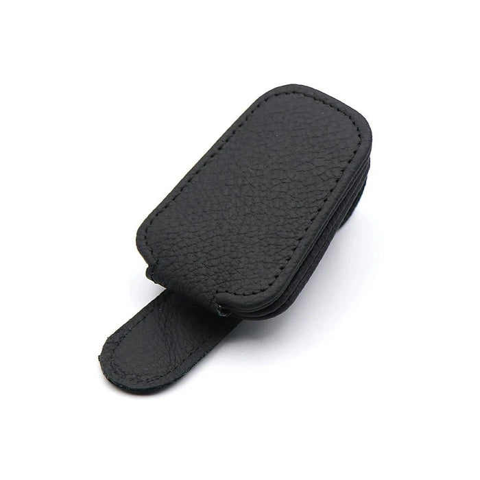 Black leather clip with a magnetic closure, lying flat.