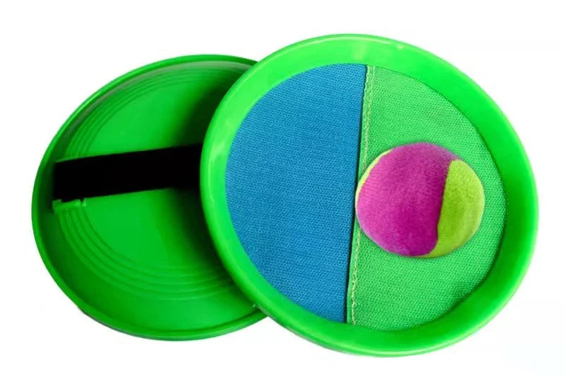 Green Velcro catch paddle with blue and green sections, paired with a pink and green ball.