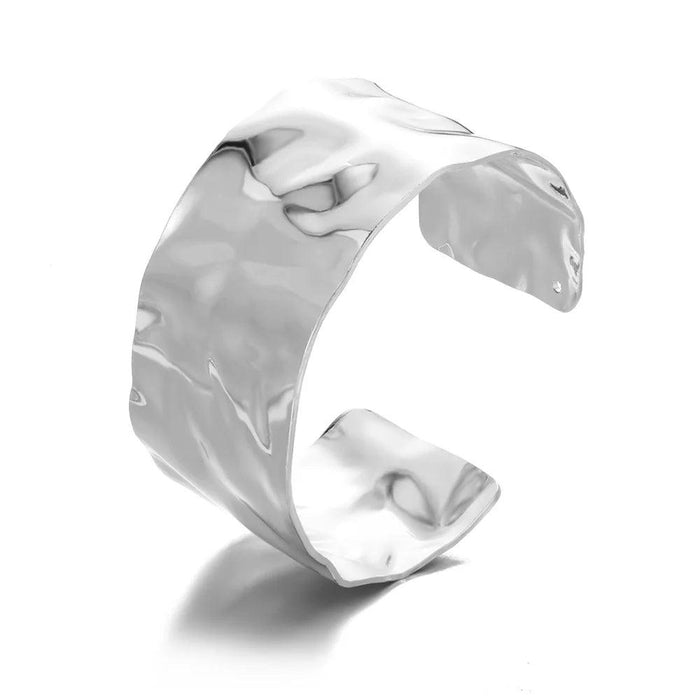 Wide silver cuff bracelet with a smooth, polished finish, displayed on a white background.