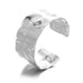 Wide silver cuff bracelet with a smooth, polished finish, displayed on a white background.