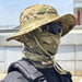 Greenish-tan camo hat with matching face cover worn by a person.