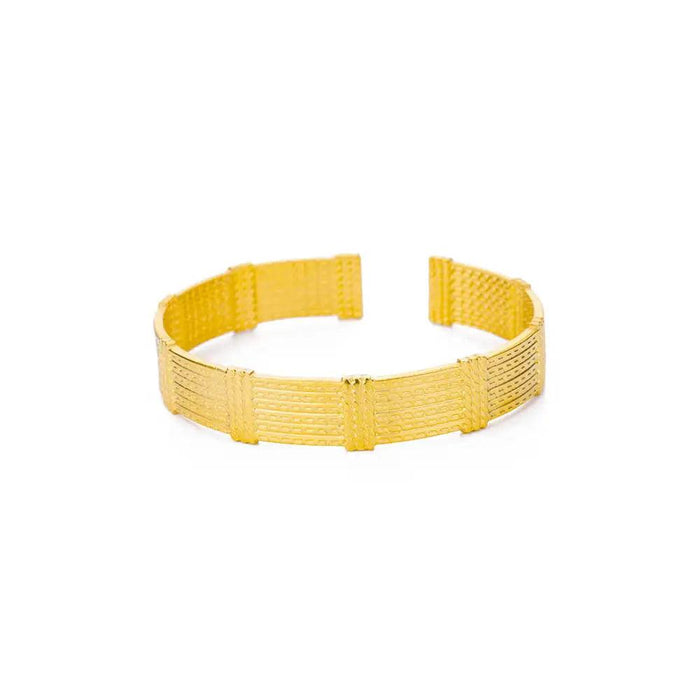 Gold textured bracelet with a woven design, displayed on a white background.