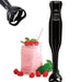 A black handheld immersion blender is shown next to a glass jar filled with a pink smoothie and topped with fresh raspberries. An enlarged image of the blender's blade is displayed in the top left corner, showcasing its sharp, efficient design.