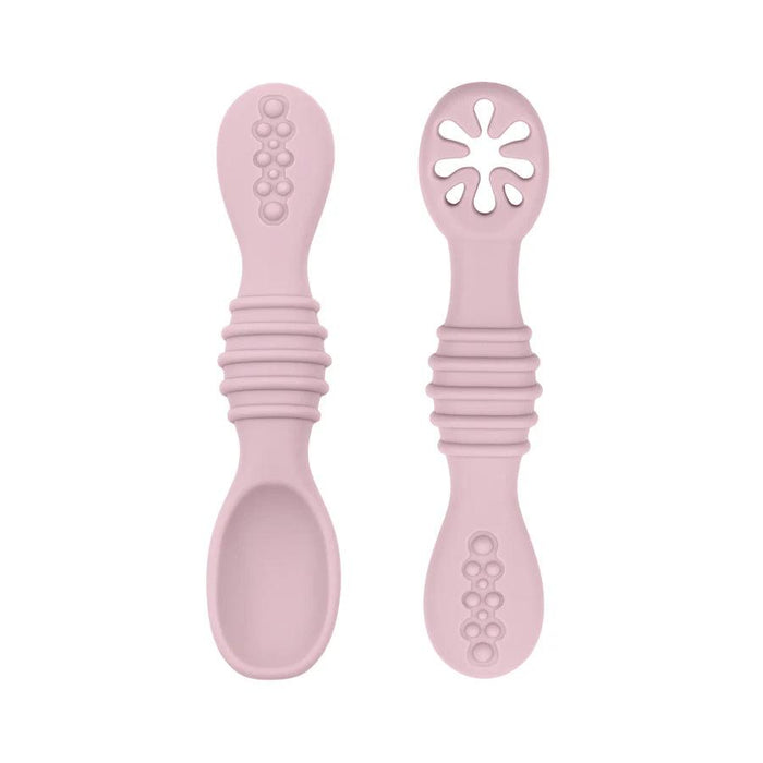 A close-up of two light purple baby spoons, one with a regular spoon shape and the other with a cut-out flower design, against a white background.