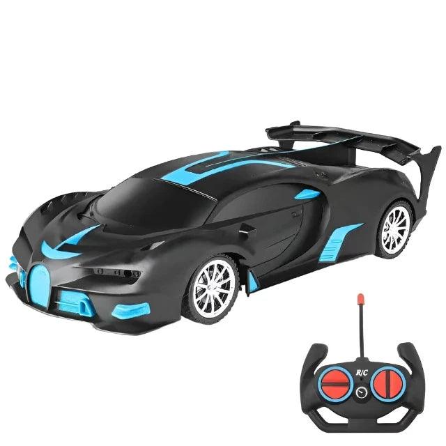 A matte black and blue sports car with black accents and an accompanying remote control. The car features a sleek, aerodynamic design and large rear spoiler.