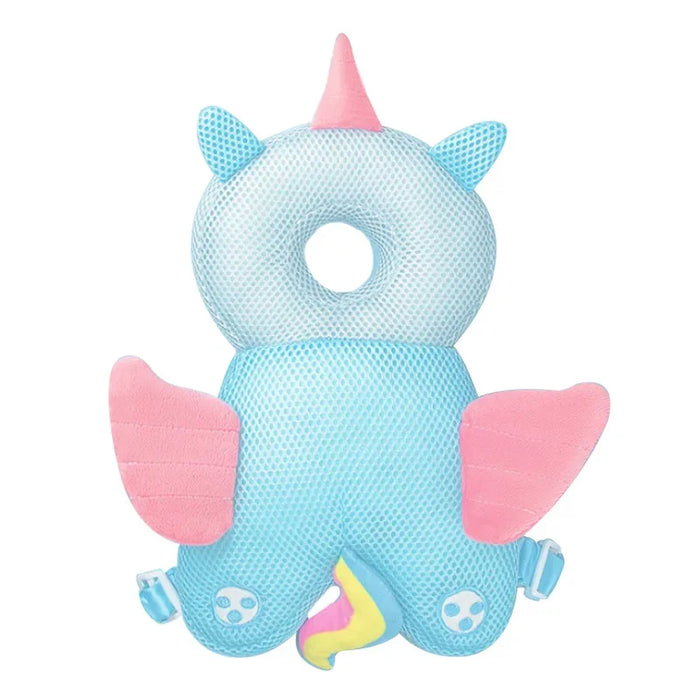 A blue unicorn-shaped baby head protector with a pink horn, wings, and tail, and a white circular headrest.