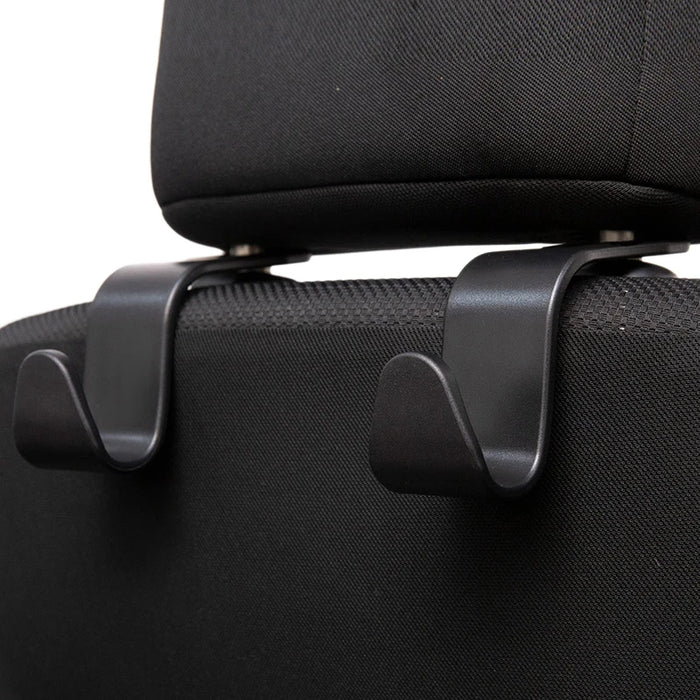 Close-up of black car seat headrest hooks attached to a black car seat.