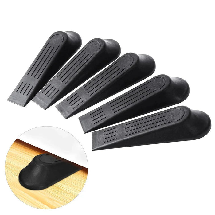 Five black rubber door stoppers arranged in a fan shape, highlighting their simple wedge design. An inset shows a close-up of one stopper being used to hold a door securely in place on a wooden floor.