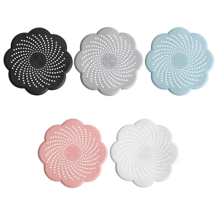 Five flower-shaped silicone drain covers in different colors (black, gray, blue, pink, and white), with a spiral pattern of holes.