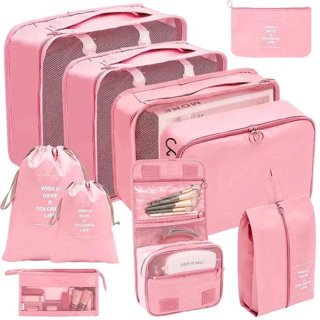 Pink travel organizer set featuring three mesh packing cubes, a drawstring bag, a toiletry bag, a small pouch and a few more bags, all coordinated with the inspirational message 'WISH U HAVE A COLORFUL LIFE'. Ideal for systematic packing and organization. Display on white background.