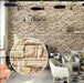 An interior wall decorated with a stacked stone design, featuring furniture and decor.