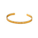 Gold cuff bracelet with Roman numerals engraved on it, displayed on a white background.