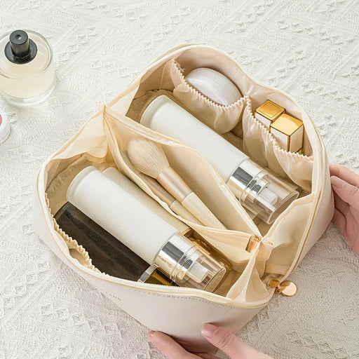 an open makeup bag neatly organized with various skincare and beauty products inside.