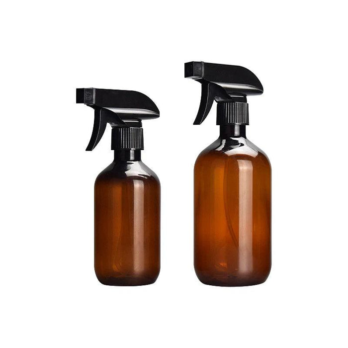 Two tan spray bottles of different sizes with black spray heads, standing side by side.