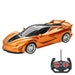 A sleek, orange sports car with black accents and an accompanying remote control.